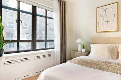 a bedroom with a white bed and a window at 52-3DE Newly renovated 2BR BTH Midtown East in New York