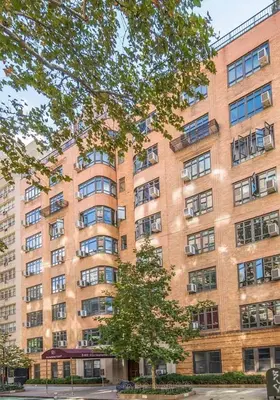 a large brick building with a tree in front of it at 52-3DE Newly renovated 2BR BTH Midtown East in New York