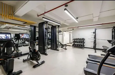 a gym with several treadmills and machines in it at 52-3DE Newly renovated 2BR BTH Midtown East in New York