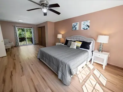 a bedroom with a bed and a ceiling fan at Horatio Hideaway Pocono Escape in Tobyhanna