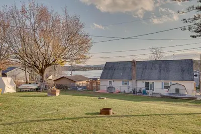 a yard with a house and a tree at Cozy Pennsylvania Home with Fire Pit and Dock Access! in Carbondale
