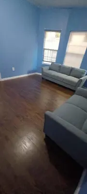 a living room with two couches and a wooden floor at willoughby inn in Newark