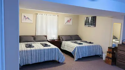 a bedroom with two beds with striped sheets at Long pond, Pocono pines quiet & cozy!Kalahari 8mins in Pocono Pines