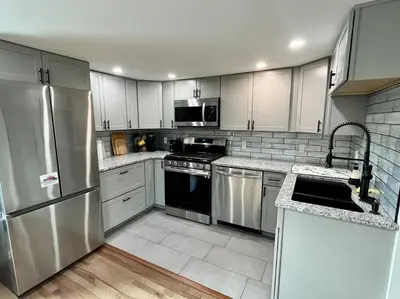 a kitchen with white cabinets and stainless steel appliances at 2 Bed Berkshire Getaway @ Stephentown Hotel in Stephentown