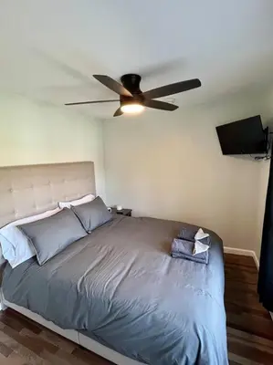 a bedroom with a bed with a ceiling fan at 2 Bed Berkshire Getaway @ Stephentown Hotel in Stephentown