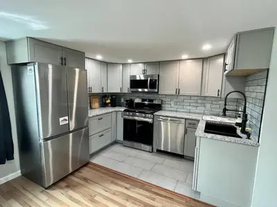 a kitchen with stainless steel appliances and white cabinets at 2 Bed Berkshire Getaway @ Stephentown Hotel in Stephentown