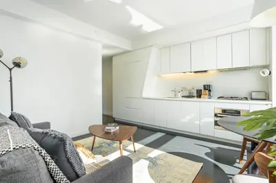 a living room with a couch and a table at Financial District 1br w WD gym elevator NYC-1362 in New York