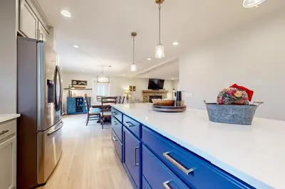 a kitchen with blue cabinets and a refrigerator at Modern Mountain Homestead in Dover