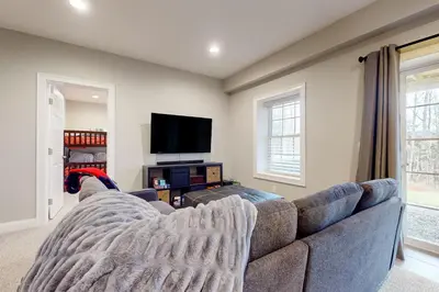 a living room with a couch and a flat screen tv at Modern Mountain Homestead in Dover