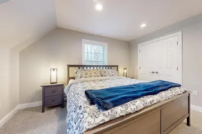 a bedroom with a king sized bed and a window at Modern Mountain Homestead in Dover