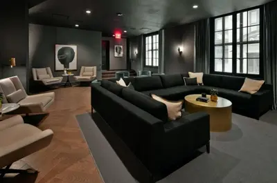 a living room with a couch and a table and chairs at FiDi jr 1br w game room resident-only bar NYC-1336 in New York