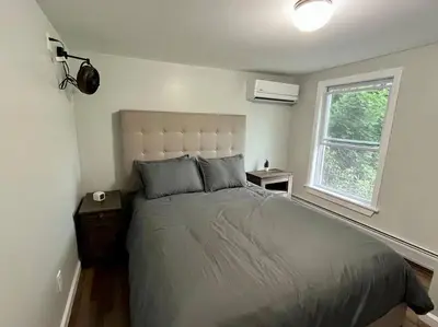 a bedroom with a bed and a window at 5 Bed / 3 bath Apt Near Jiminy Peak Berkshires in Stephentown