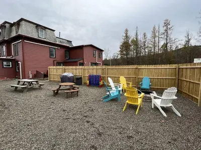 a group of chairs and tables and a fence at 5 Bed / 3 bath Apt Near Jiminy Peak Berkshires in Stephentown