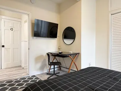 a bedroom with a desk and a television on the wall at 2-A Diamond in Yonkers in Yonkers