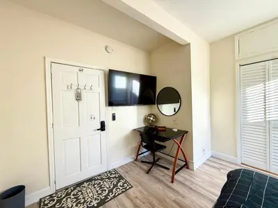 a room with a door and a table and a mirror at 2-A Diamond in Yonkers in Yonkers