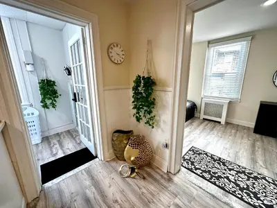 a living room with a clock on the wall at 2-A Diamond in Yonkers in Yonkers