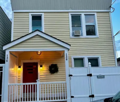 a house with a white door and a white fence at 2-A Diamond in Yonkers in Yonkers