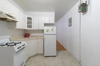 a kitchen with white appliances and a white refrigerator at The Upper East Side Monthly Rentals Apartments in New York
