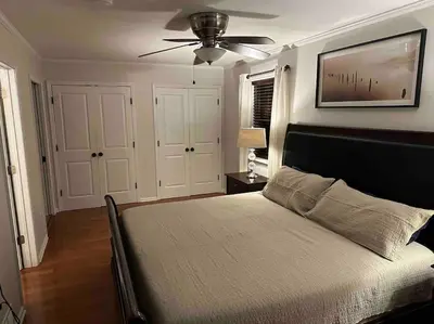 a bedroom with a bed with a ceiling fan at The Gray Horse in Saratoga Springs