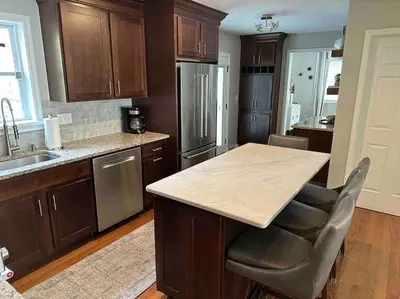 a kitchen with wooden cabinets and a wooden counter top at The Gray Horse in Saratoga Springs