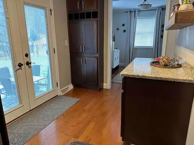 a kitchen with wooden floors and a counter top at The Gray Horse in Saratoga Springs