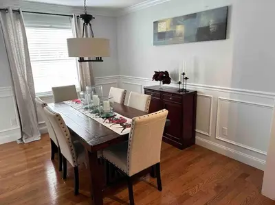 a dining room with a wooden table and chairs at The Gray Horse in Saratoga Springs