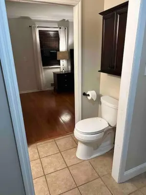 a bathroom with a white toilet in a room at The Gray Horse in Saratoga Springs