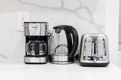 three appliances sitting on a shelf in a kitchen at 317-1AN - New Modern 1BR W&D Walk to Central Park in New York