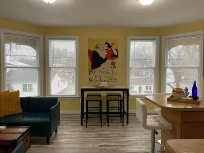 a living room with a couch and a table at 2 BR Loft - Walk to Cafes-Breweries- Arts & Entertainment District in Glens Falls