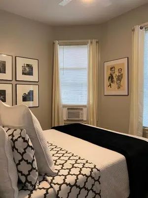 a bedroom with a bed and a window at 2 BR Loft - Walk to Cafes-Breweries- Arts & Entertainment District in Glens Falls