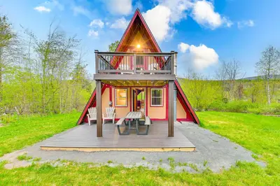 a small house with a porch and a deck at Walk to Ski Lift! Charming Hunter A-Frame in Lanesville