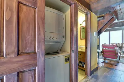 a kitchen with a washer and dryer in a house at Walk to Ski Lift! Charming Hunter A-Frame in Lanesville