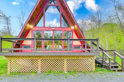 a tiny house with a red roof and a staircase at Walk to Ski Lift! Charming Hunter A-Frame in Lanesville