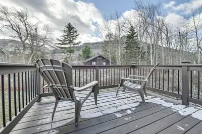 a pair of chairs sitting on a wooden deck at Walk to Ski Lift! Charming Hunter A-Frame in Lanesville