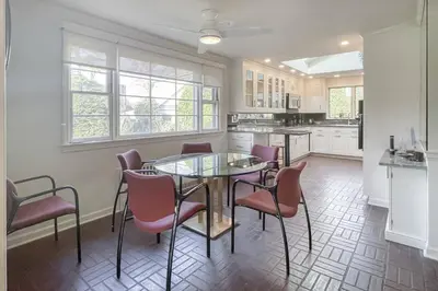 a kitchen with a glass table and chairs at Luke's Landing in Westport
