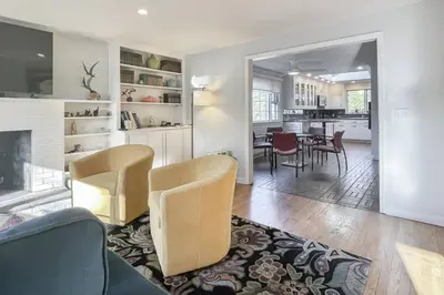 a living room with chairs and a dining room at Luke's Landing in Westport