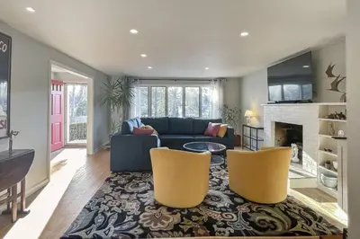 a living room with a blue couch and two yellow chairs at Luke's Landing in Westport