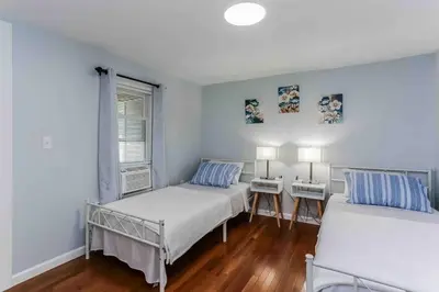 a bedroom with two beds and a window at Two Bedroom Apartment on Forestville Bristol in Bristol