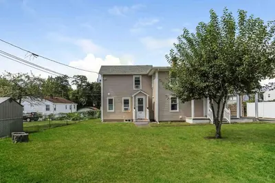 a house with a tree in a yard at Two Bedroom Apartment on Forestville Bristol in Bristol