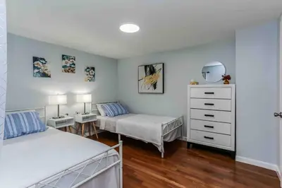a bedroom with two beds and a dresser at Two Bedroom Apartment on Forestville Bristol in Bristol