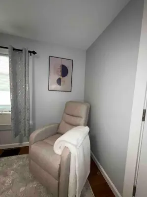a living room with a chair and a window at Two Bedroom Apartment on Forestville Bristol in Bristol