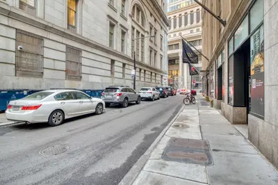 a street with cars parked on the side of the road at FiDi 1br w gym doorman lounge nr park NYC-1344 in New York