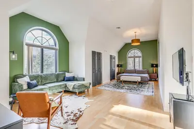 a living room with green walls and a couch at Secluded Kerhonkson Retreat with Deck and Views! in Sundown