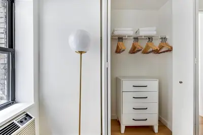 a room with a closet with a dresser and shoes at Hudson Yards 1br w gym wd nr penn station NYC-1308 in New York