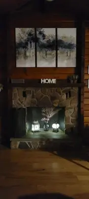 a stone fireplace in a living room with a window at Comfy Log Cabin Family & Pet Kind by State & Waterparks! in Tobyhanna
