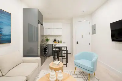a living room with a couch and a table at 317-2A Sleek Modern 1Br UES W D in New York