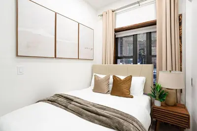 a bedroom with a bed and a window at 317-1B Modern 1Br UES W D in New York