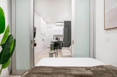 a bedroom with a bed and a living room at 317-1B Modern 1Br UES W D in New York