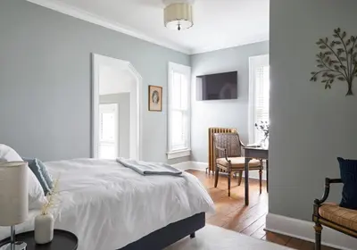 a bedroom with a bed and a table and a chair at The Kent Collection - The Victorian in Kent