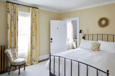 a bedroom with a bed and a chair and a window at The Kent Collection - The Victorian in Kent